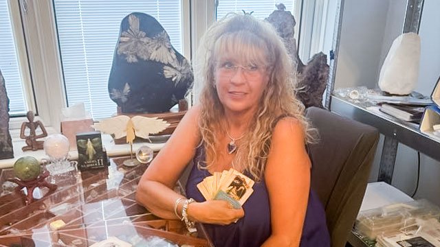 Your card reading presenter holding oracle cards